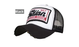 Macro detail of embroidered patch and distressed brim on vintage black trucker hat