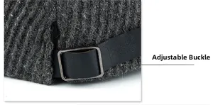 Detail of adjustment buckle and leather strap on dark grey wool knit newsboy cap
