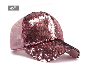 Detail view of rose gold sequins on front crown and breathable mesh of trucker baseball cap