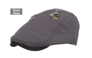 Detailed view of dark gray beret with floral embroidery, jacquard texture, and retro buckle