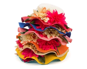 Detailed texture of hand-woven straw hats with large artificial flowers in vibrant colors