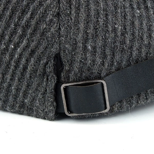 Dark grey wool blend cap featuring ribbed texture and adjustable faux leather metal buckle