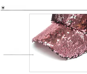 Close-up of shiny pink sequins on a baseball cap brim with metallic reflective finish