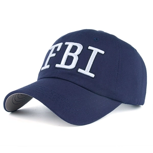 Detailed view of white FBI letter embroidery on dark blue cotton twill baseball cap