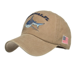Detail view of khaki cotton baseball cap with blue shark embroidery and flag patch