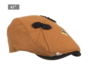 Detail view of ginger brown newsboy hat with vintage floral embroidery and Chinese buttons