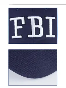Detailed view of white FBI embroidery and precise stitching on navy blue cotton baseball cap