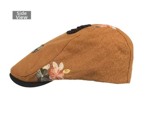 Side view of brown vintage newsboy hat with floral embroidery and textured fabric