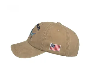 Detailed side view of khaki cotton baseball cap with American flag and marlin embroidery