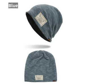 Close-up of blue knit beanie with ROCK woven patch and soft black thermal lining detail