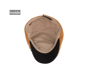 Detail view of vintage newsboy cap interior showing beige lining and floral embroidery