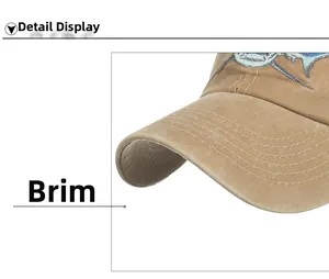 Close-up of khaki cotton twill baseball cap brim with blue shark embroidery detail