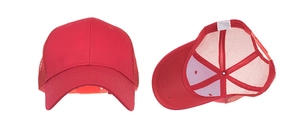 Detail view of red mesh trucker hat showing cotton blend fabric and inner lining labels