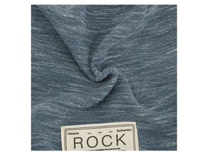 Macro shot of blue melange knit texture and vintage style woven label on beanies