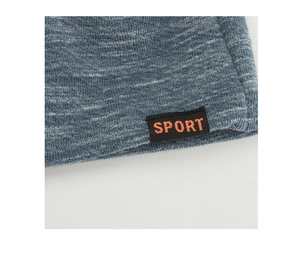 Detail of blue marl knitted beanie fabric with a black SPORT woven label patch