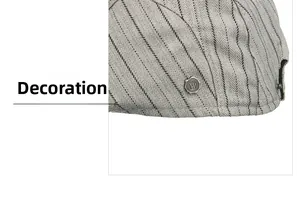 Detail of grey newsboy cap showing herringbone fabric and vintage metal letter W badge
