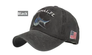 Detailed close-up of shark embroidery on a washed cotton black baseball cap with flag patch