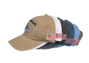 Close-up detail of embroidered marlin fish and flags on multi-colored baseball caps