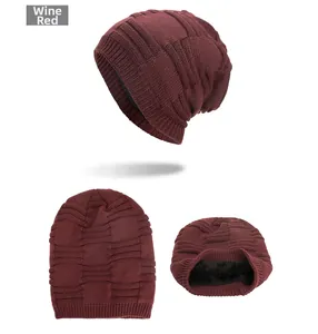 Detailed macro view of the wine red knit beanie showing thick fleece lining and grid texture