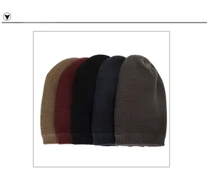 Detailed view of knitted beanie hats in five solid colors with ribbed cuffs texture