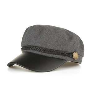 Detail of grey wool newsboy cap with black leather brim and golden decorative buttons