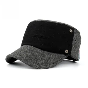 Detail of the stitching and metal rivet on a dark grey flat top military cap for men