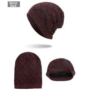 Detail of burgundy diamond-pattern knit beanie featuring thick black fleece lining