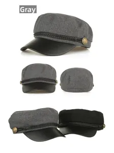 Detail view of newsboy cap featuring grey wool fabric, black PU brim and braided cord decoration
