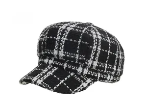 Detailed 45-degree side view of a black and white checkered tweed newsboy cap