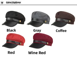 Detail view of newsboy hats in five colors with faux leather brim and gold metal button