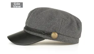 Side view of dark gray wool newsboy cap with black faux leather brim and braided cord