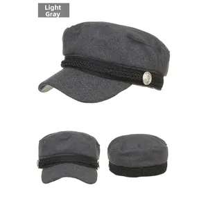 Detail of light gray wool military cap with braided band and anchor button accent