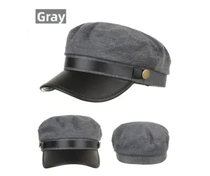 Detail view of grey military style baker boy hat with black faux leather brim and gold buckle