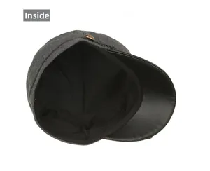 Detailed interior view of grey wool newsboy hat featuring black lining and braided trim