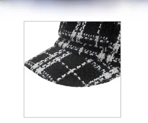 Detail showing classic black and white checkered tweed fabric of the women's beret hat