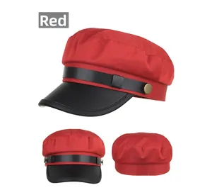 Detailed front, side and back views of red knit newsboy cap with black leather brim