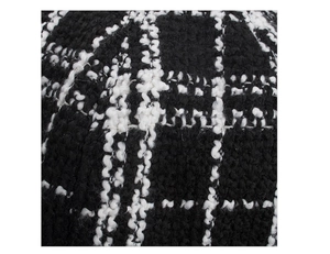 Close-up macro of black and white plaid knit fabric texture on the beret