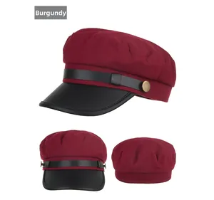 Detail view of wine red baker boy hat with black leather brim and metal rivets from three angles