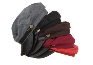Detail of fabric baker boy hats with faux leather brims and vintage gold buckles