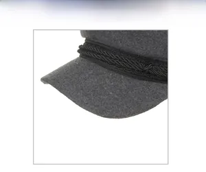 Detail view of dark grey wool baker boy hat with black braided rope and fabric texture