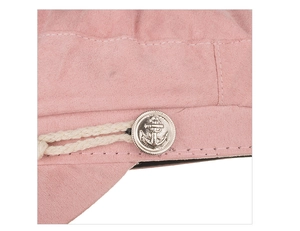 Detail of pink military beret featuring a woven cord and silver anchor relief button