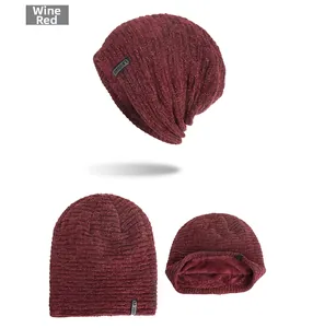 Detailed view of burgundy knit beanie with warm fleece lining and black leather label