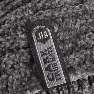 Deep gray plush knit beanie with soft chenille texture and a woven brand label detail