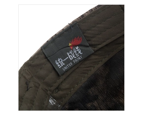 Detailed close-up showing the green camouflage fabric and stitching with inner brand tag
