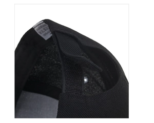 Detail of adjustable Velcro strap and 100% acrylic material label on black baseball cap