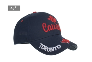 Detail of embroidered Canada script and maple leaf on navy cotton baseball cap