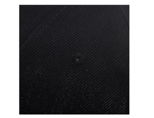 Close-up of black cotton twill fabric with a stitched ventilation eyelet on the baseball cap