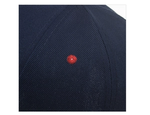 Close-up detail of navy baseball cap showing high-quality twill fabric and red eyelet embroidery