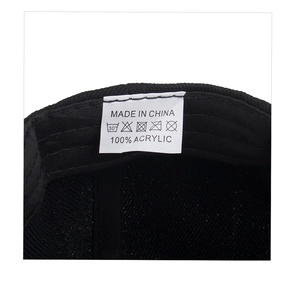 Detail view of the 100% acrylic interior wash label and care instructions for the black cap
