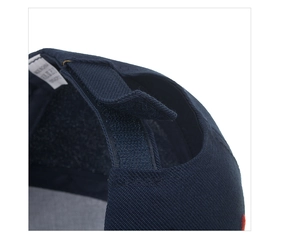 Close-up of adjustable velcro strap and wash label inside the navy blue baseball cap